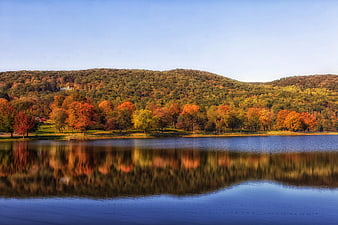 Serene Lake with Vibrant Autumn Trees and Mountain Reflection