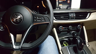 Alfa Romeo car interior dashboard and steering wheel view