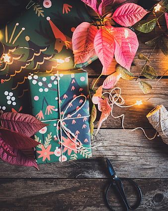 Rustic Christmas Gifts Wrapped on Wooden Table with Poinsettias