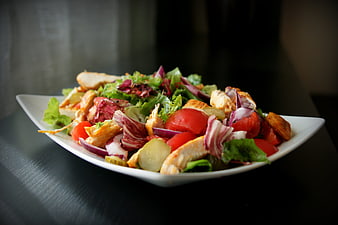 Healthy Chicken Salad with Tomatoes and Radicchio on White Plate