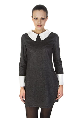 Young woman wearing a dark grey dress with white collar and cuffs