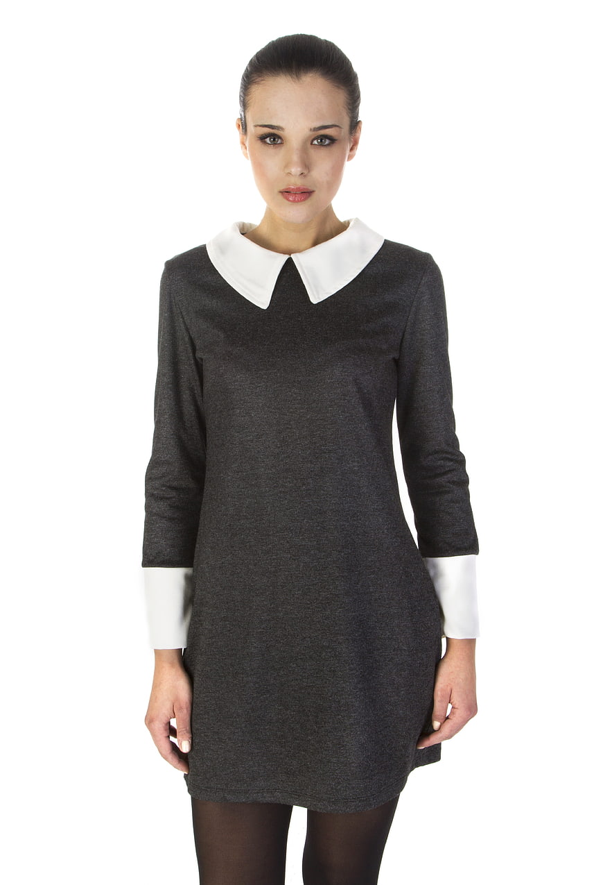 Young woman wearing a dark grey dress with white collar and cuffs