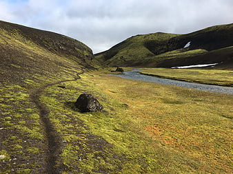 Mossy Icelandic Valley with Winding River and Snow Patches