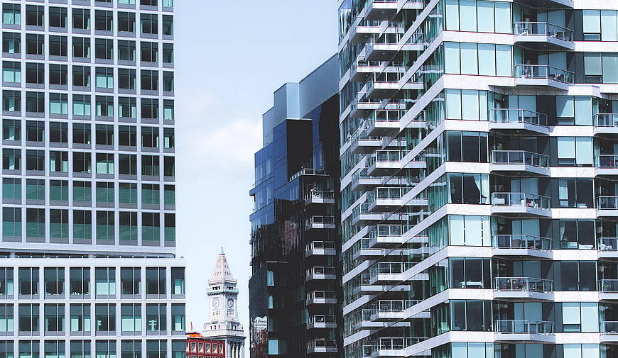 Modern Glass Skyscrapers and Historic Clock Tower
