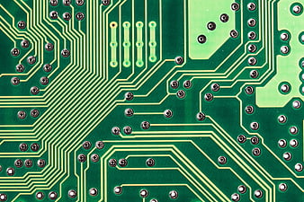 Close-up of green printed circuit board with gold traces
