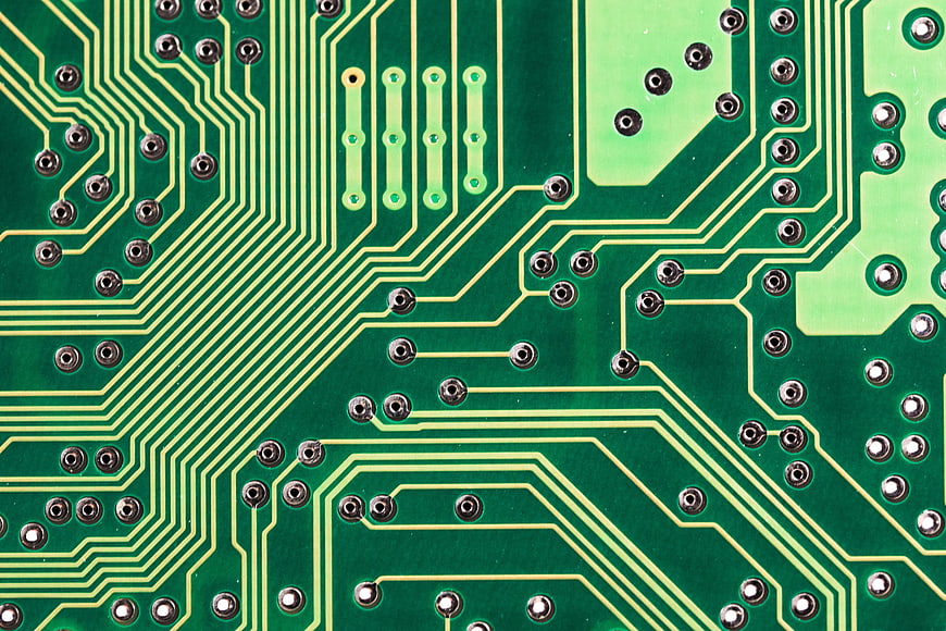 Close-up of green printed circuit board with gold traces