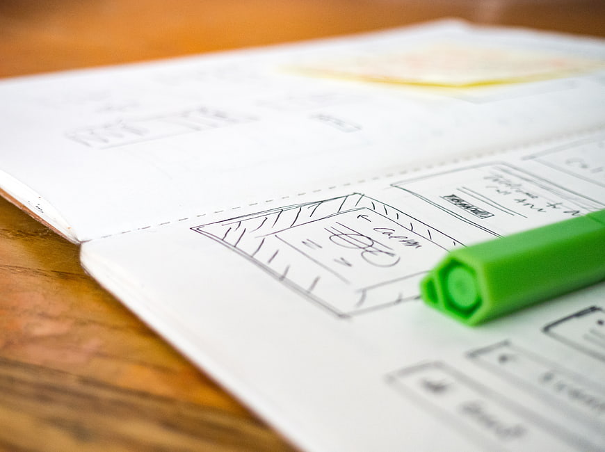 UX Wireframe Sketch in Notebook with Green Pen