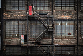 Abandoned industrial brick building with metal fire escape