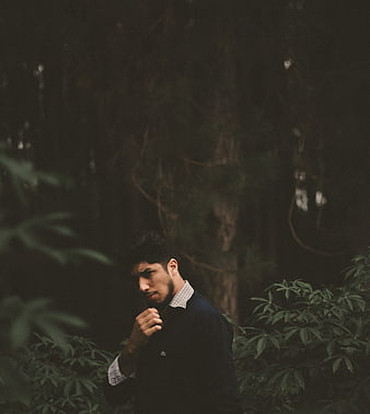 Moody portrait of a man in a dark forest