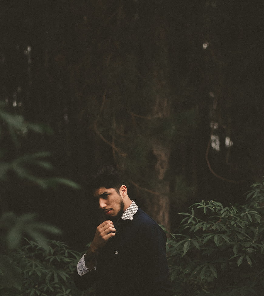 Moody portrait of a man in a dark forest