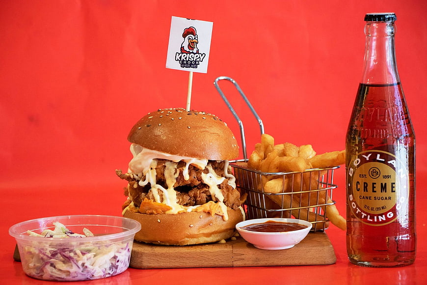 Korean Fried Chicken Burger with Fries and Soda on Red Background