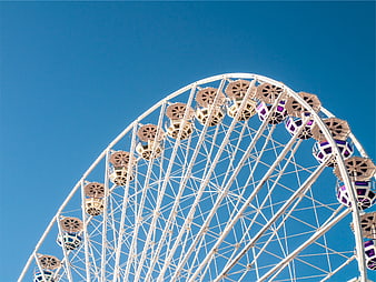 White Ferris Wheel Against Clear Blue Sky