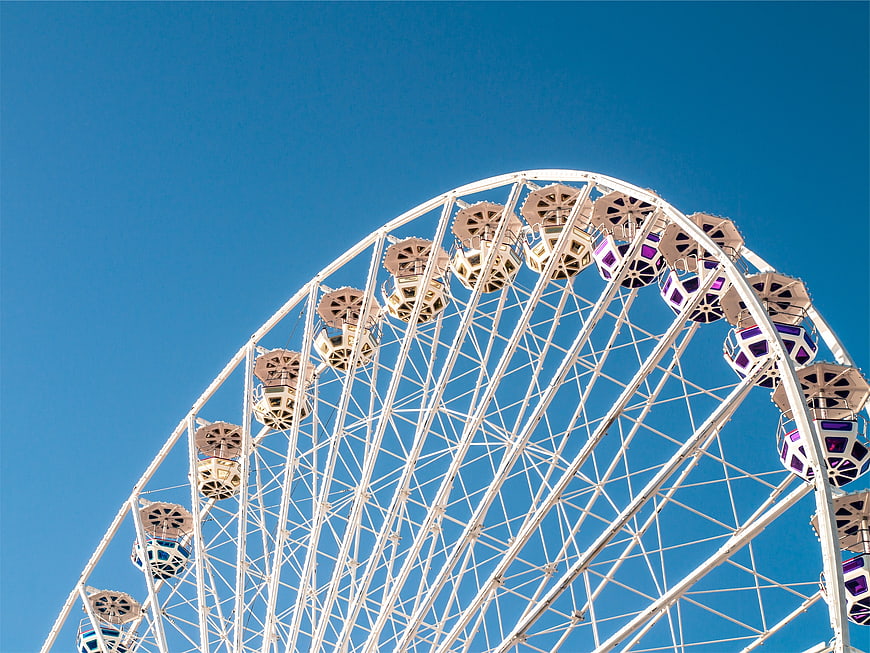 White Ferris Wheel Against Clear Blue Sky