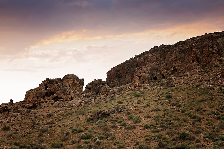 Rugged desert landscape with rocky formations at sunset