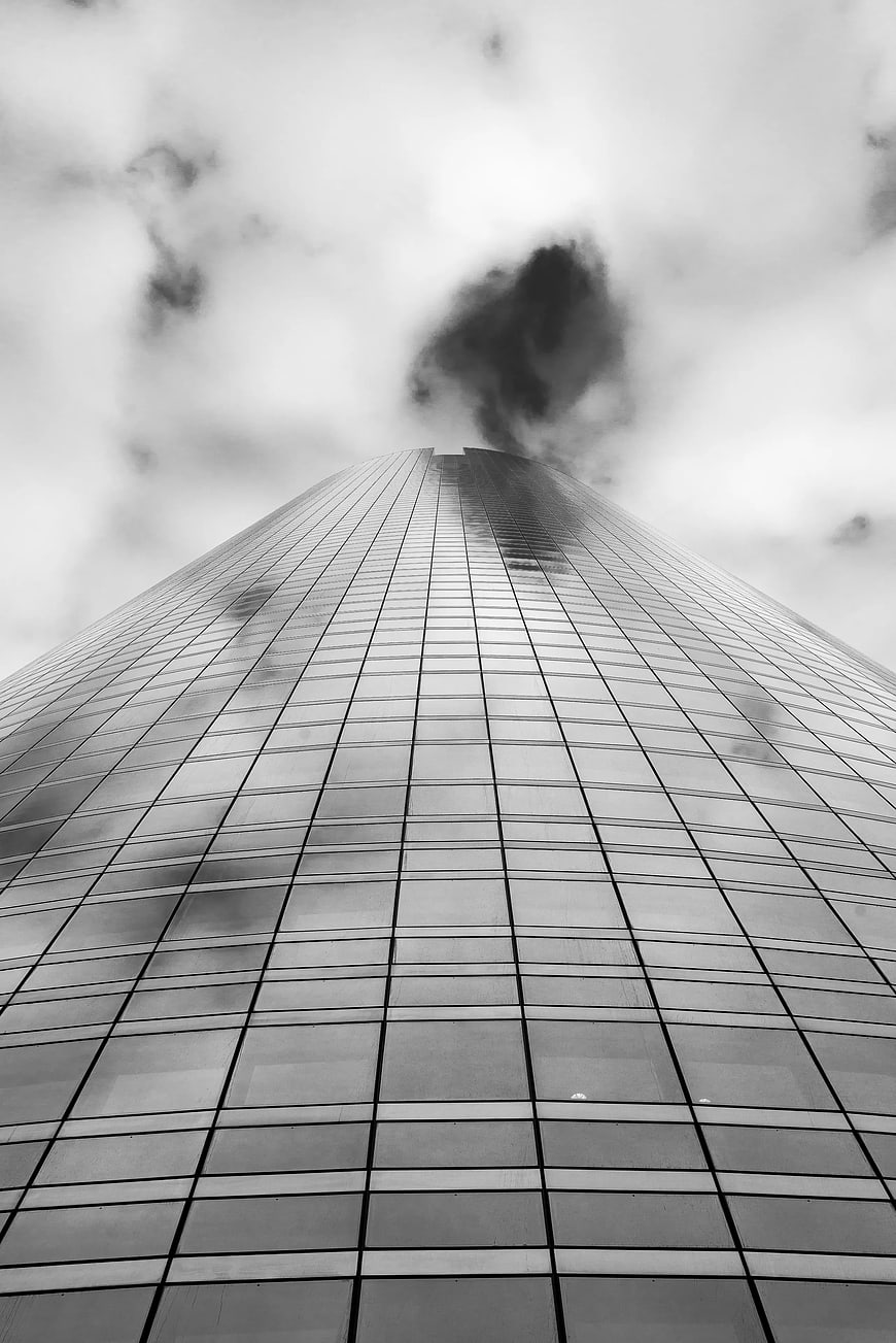 Black and white worm's eye view of modern skyscraper