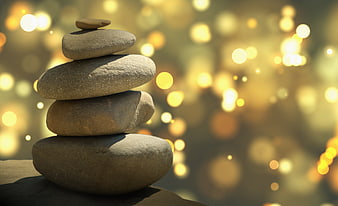 Stacked Zen Stones with Golden Bokeh Background
