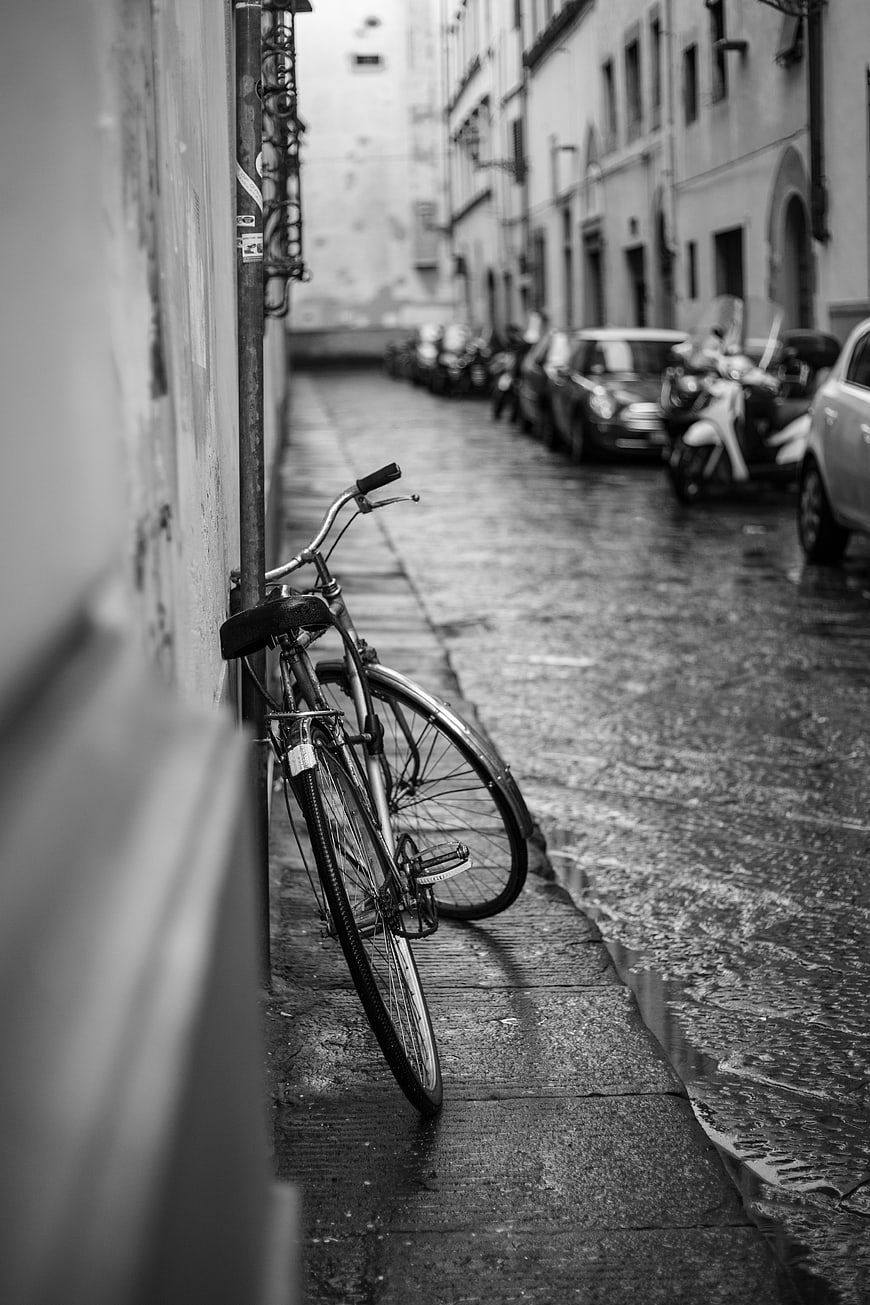 Vintage Bicycle Parked on Wet Cobblestone Street
