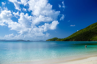 Tropical beach with turquoise water, white sand, and blue sky