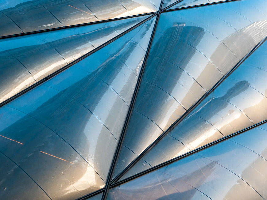 Abstract Blue Glass Facade with City Reflections