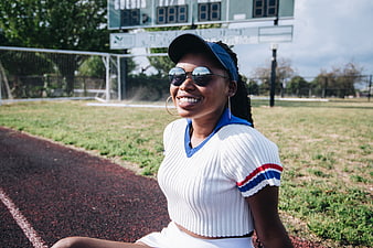 Smiling Black Woman in Sporty Outfit on Track
