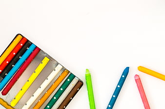 Colorful Crayons in Tin Box on White Background