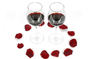 Two glasses of red wine with rose petals on white background
