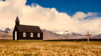 Black Church in Iceland with Mountains and Blue Sky