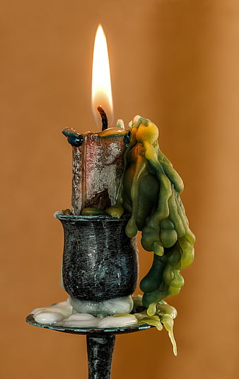 Burning Green Candle with Melted Wax in Vintage Holder