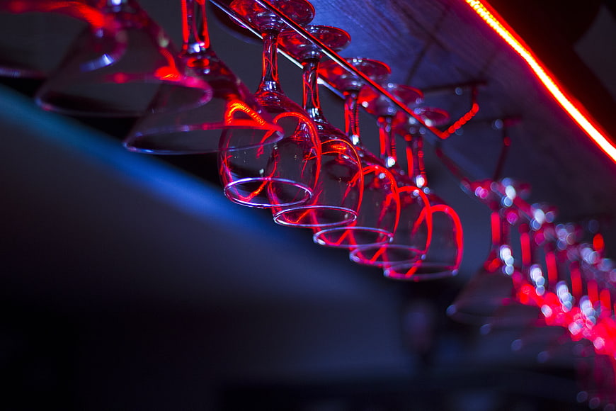 Red Neon Wine Glasses Hanging in a Bar