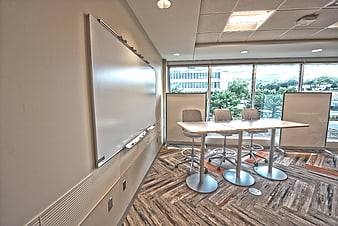 Modern empty meeting room with whiteboard and city view