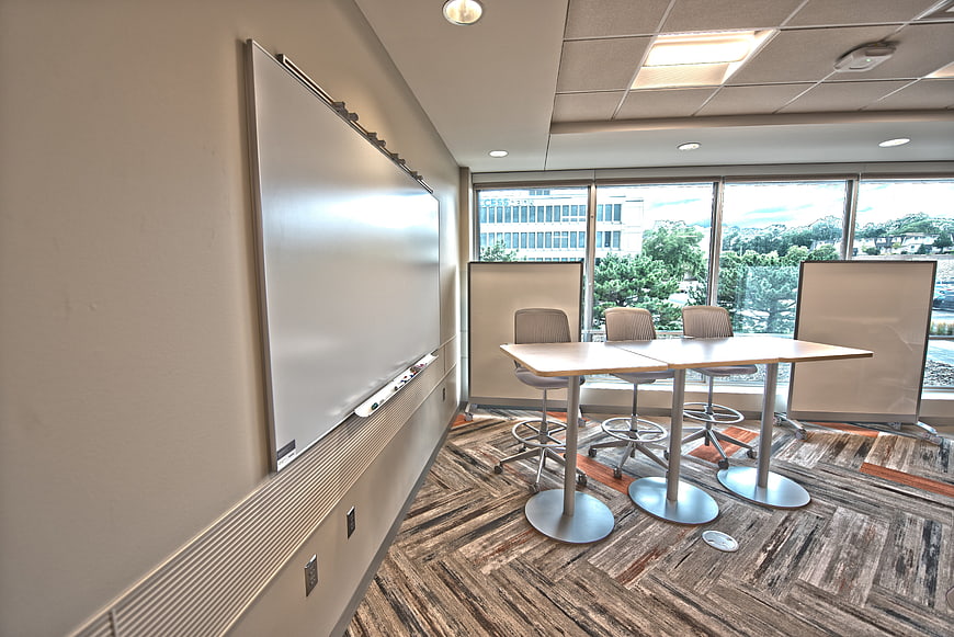 Modern empty meeting room with whiteboard and city view