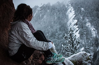 Woman hiking in snowy mountain landscape