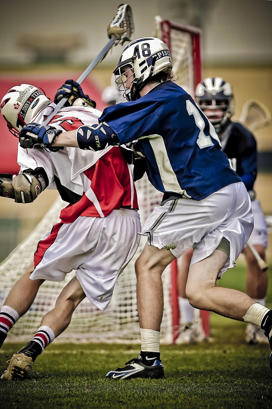 Lacrosse players battling for position on the field