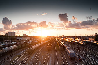 Sunset over Train Yard with Freight Trains and Tracks