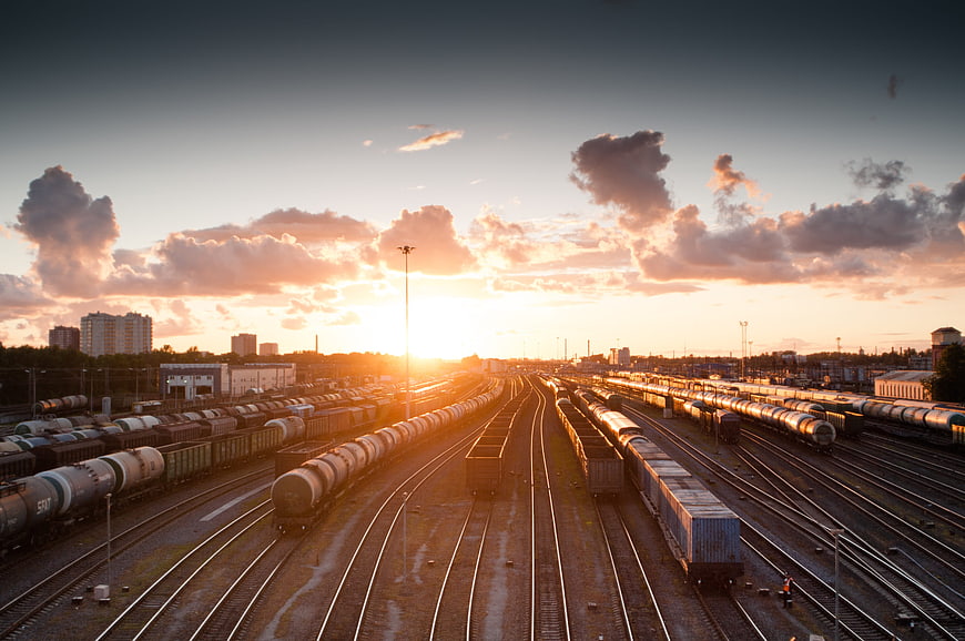 Sunset over Train Yard with Freight Trains and Tracks