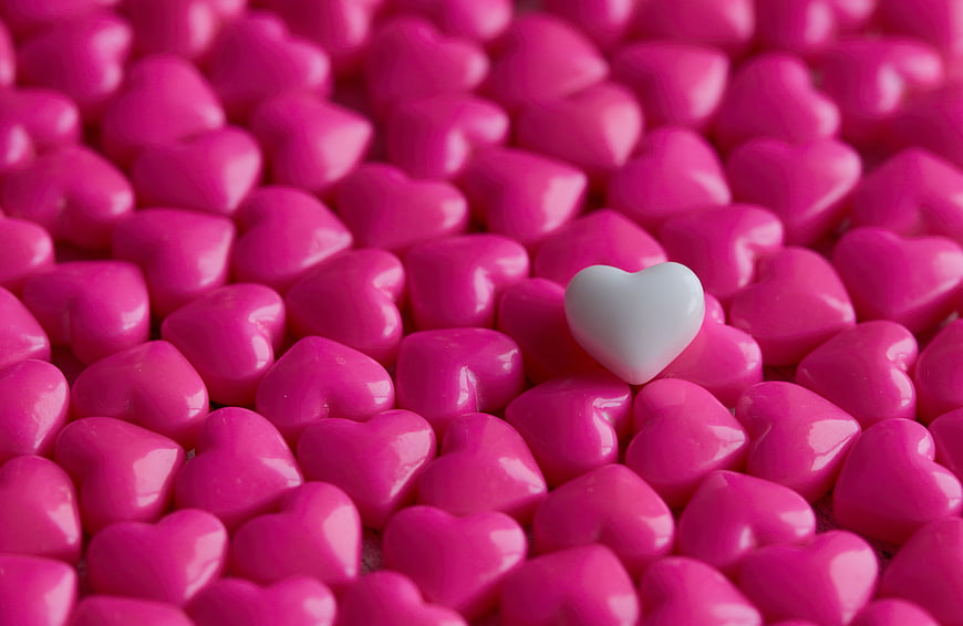 White Heart Candy Among Pink Hearts Background
