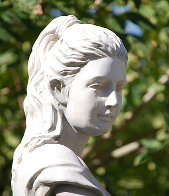 White Marble Statue of a Woman in a Garden