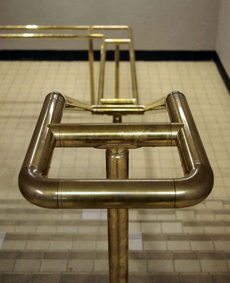 Brass Bike Rack in Tiled Corridor