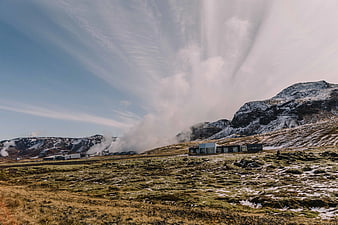 Modern House Near Geothermal Power Plant in Snowy Landscape
