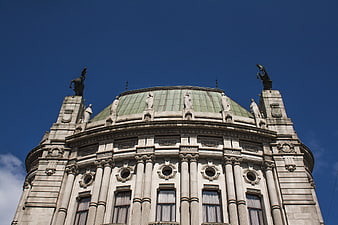 Low angle view of ornate classical building dome against blue sky