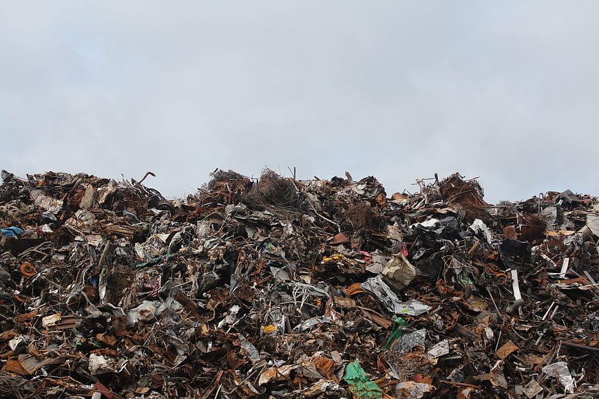 Large pile of scrap metal and industrial waste in a junkyard