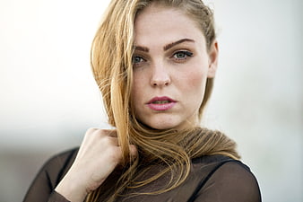 Blonde Woman Portrait With Windblown Hair And Direct Gaze