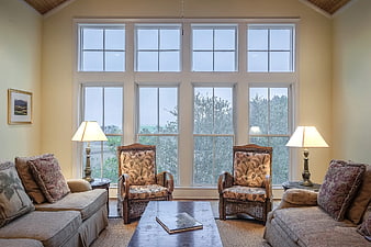 Cozy Living Room with Large Windows and Wicker Chairs