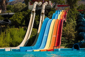 Colorful Water Park Slides Descending Into Pool