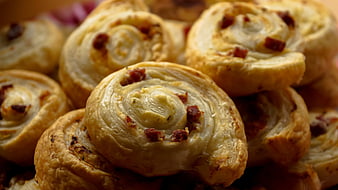 Close-up of golden baked pastry rolls with savory filling