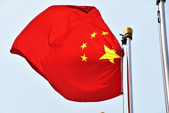 Chinese National Flag Waving Against Clear Blue Sky