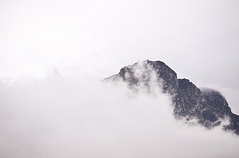 Misty Mountain Peak Emerging Through Thick Fog