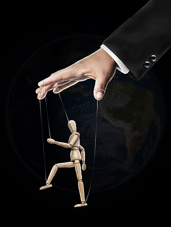 Business hand controlling wooden puppet with globe background