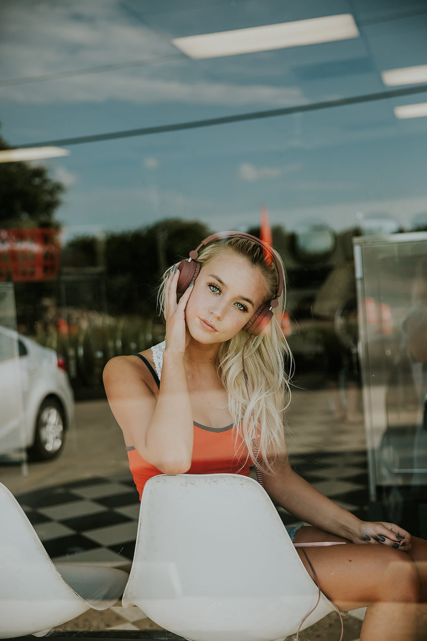 Young Blonde Woman Listening to Music with Headphones