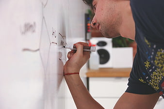 Man Writing on Whiteboard in Modern Office